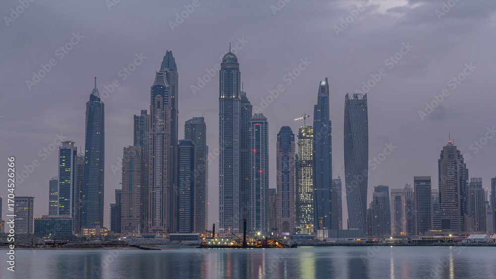 Naklejka premium Panorama of modern skyscrapers in Dubai city night to day timelapse from the Palm Jumeirah Island.