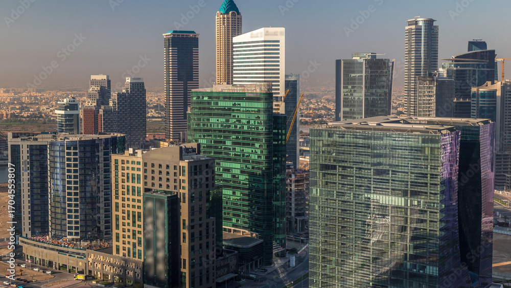 Fototapeta premium Dubai's business bay towers at morning aerial timelapse.