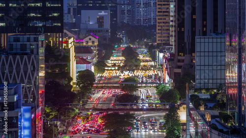 Photography Traffic with cars on a street and urban scene in the central district of Singapo