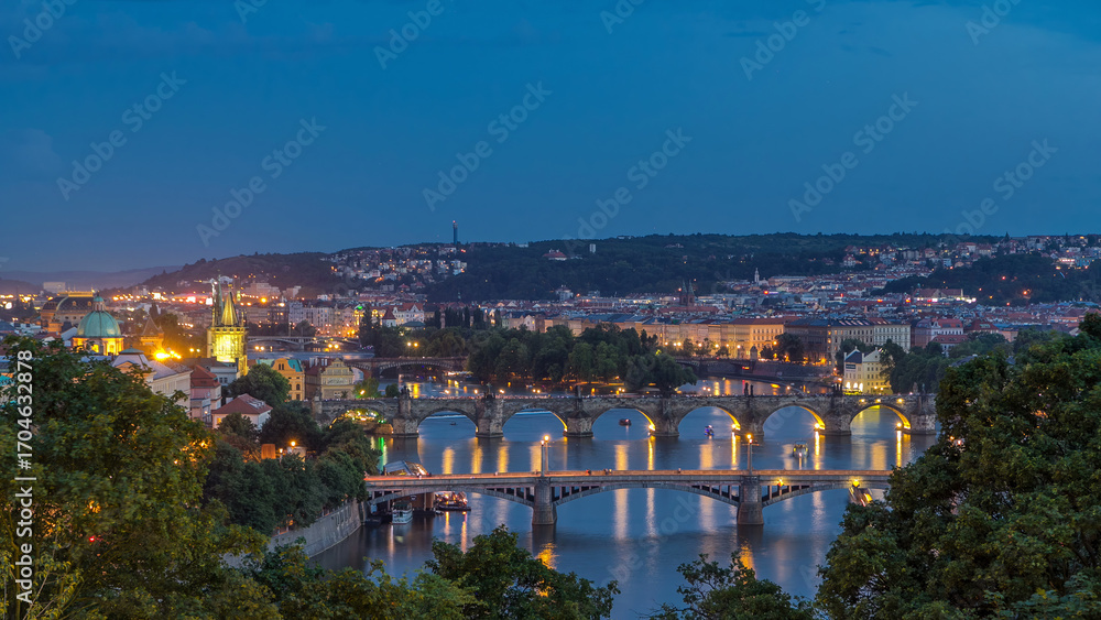 Fototapeta premium Scenic view of bridges on the Vltava river day to night timelapse and of the historical center of Prague: buildings