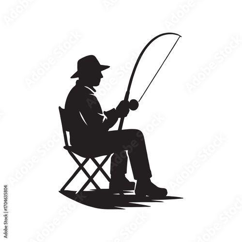 Silhouette of a fisherman sitting on a folding chair patiently waiting for a catch with his rod and reel enjoying a peaceful day of angling