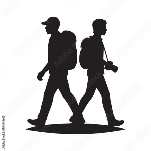 Silhouette of Two Hikers Backpacking and Walking in Opposite Directions representing teamwork partnership or a journey with one holding a camera to capture memories