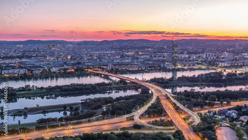 Canvas Print Aerial panoramic view over Vienna city with skyscrapers, historic buildings and a riverside promenade day to night timelapse in Austria