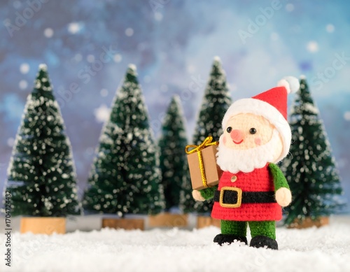 Crochet Santa with gift in snowy forest