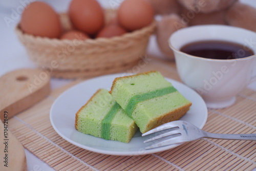 Delicious Pandan Chiffon Cake Slices with Tea and Eggs