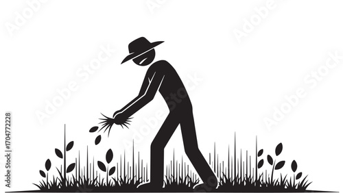 Silhouette of a farmer planting seeds in a field