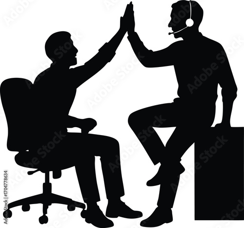 Silhouette of two businessmen celebrating success with a high five