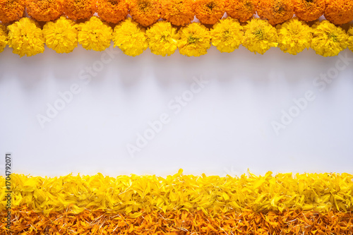 Decorative colorful marigold flowers and petals rangoli for Diwali festival with white space background.