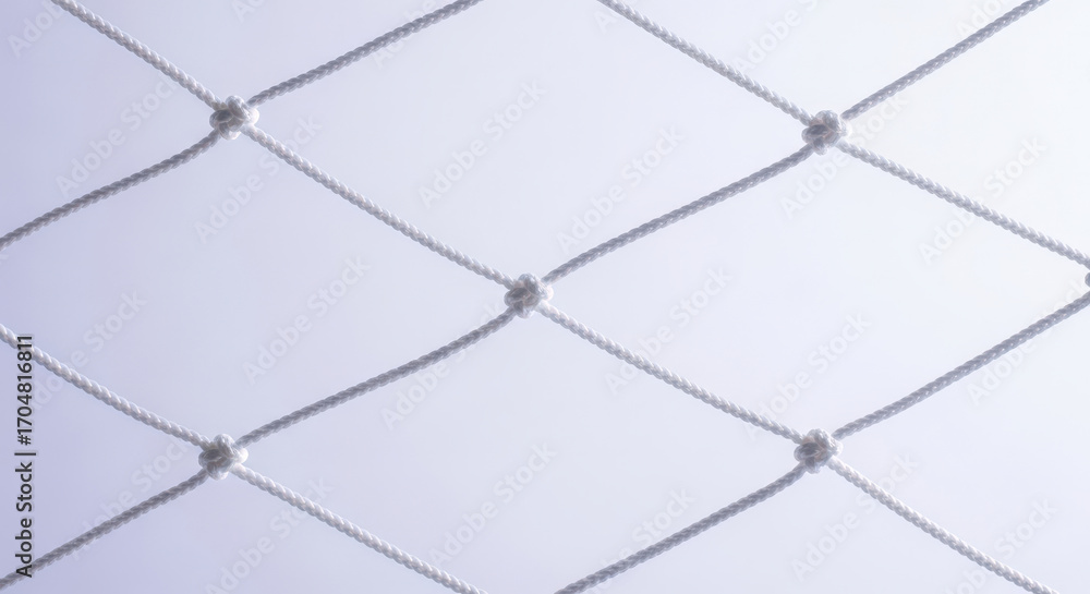 Fototapeta premium White Rope Netting Against a Light Background A Close Up of Interwoven Cord Creating a Geometric Pattern with Knots for Abstract Visual Texture