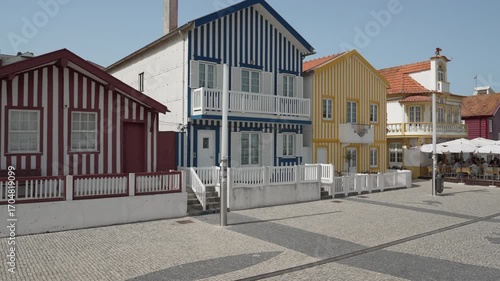 famous colorful striped houses along the promenade of the fisherman village of Costa Nova along the coastline of the atlantic ocean in Portugal.