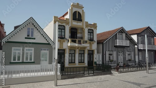 famous colorful striped houses along the promenade of the fisherman village of Costa Nova along the coastline of the atlantic ocean in Portugal.