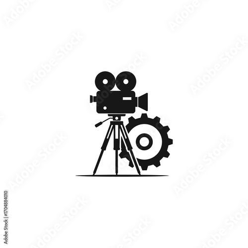 Silhouette of a vintage movie camera on a tripod, next to a gear, suggesting film production or cinema.