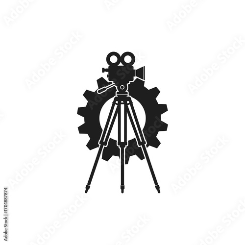 Vintage film camera mounted on a tripod, silhouetted against a large cogwheel, symbolizing the intersection of filmmaking and industry.