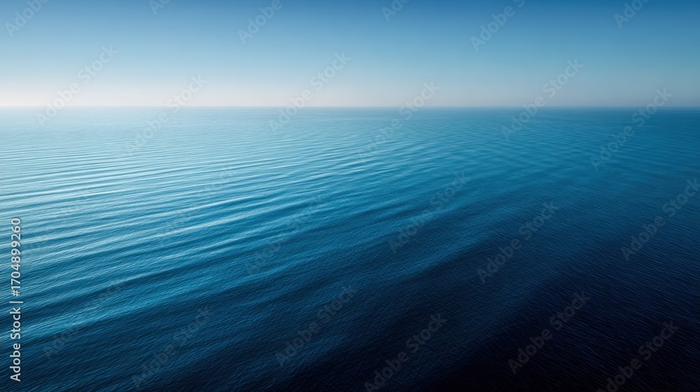 Obraz premium Oceanic Serenity: An ethereal capture of the endless ocean, where the vast expanse of water meets the sky at the horizon, creating a minimalist seascape of pure tranquility and peace.
