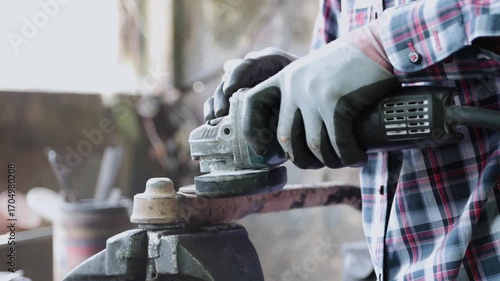 Construction Industrial Factory or Metalwork Concept by Mechanic or Technician Using Grinder with Auto Part Workshop