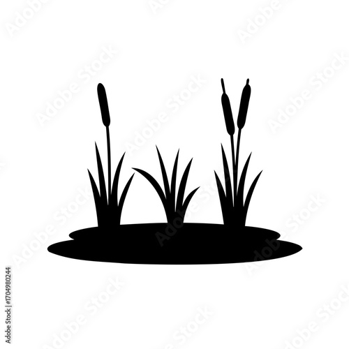 Silhouette of cattails and grass near water edge in marsh area