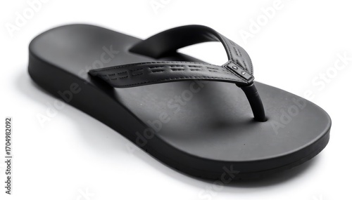 Single black flip-flop on white background, close-up, footwear, isolated