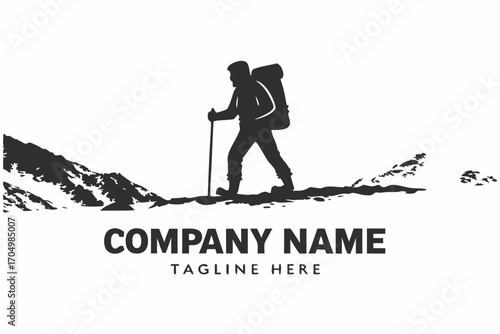 Hiker silhouette with backpack walks uphill using trekking pole across hilly terrain