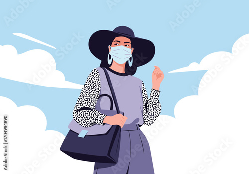 A stylish woman wearing a mask and a hat walks outdoors with her bag