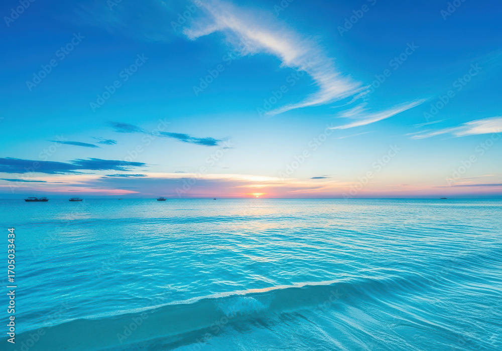 Obraz premium Vibrant blue ocean waves under a colorful sunset sky