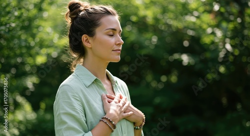 Fototapeta Naklejka Na Ścianę i Meble -  Serene Outdoor Portrait of Woman in Green Shirt Practicing Mindfulness