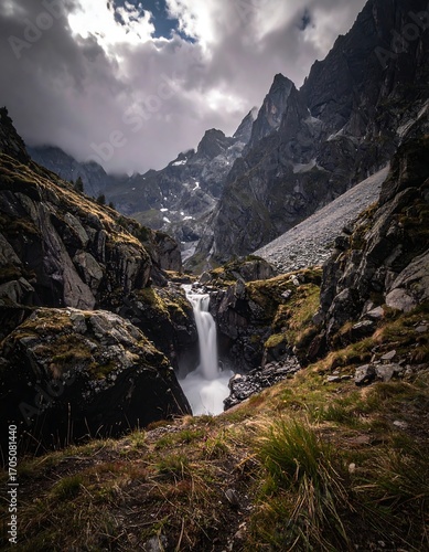 Mountain waterfall cascading down rocky gorge