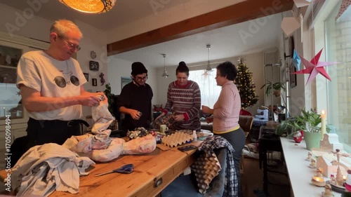 Latin American Traditions for Christmas and New Year in Europe Four members of a family preparing an año viejo effigy, a Latin American Ecuadorian tradition for New Year's Eve