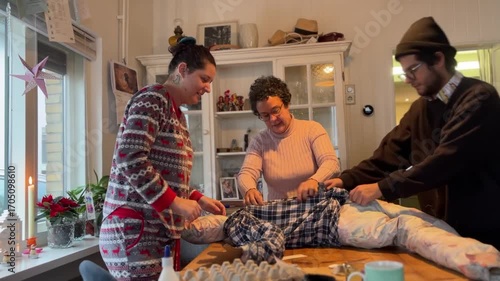 Latin American Traditions for Christmas New Year in Europe Group of latin family preparing an año viejo effigy a Latin American Ecuadorian tradition for New Year's Eve using old clothes and cardboard