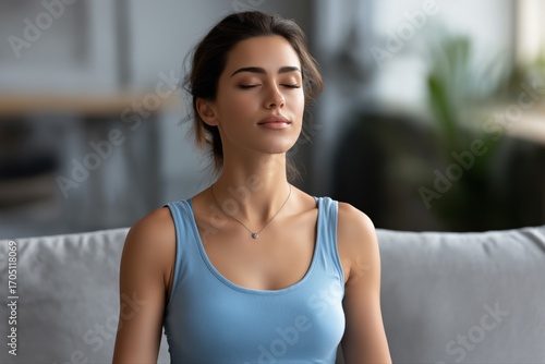 Free Download Young caucasian female practicing mindfulness meditation on sofa - GFXLoad