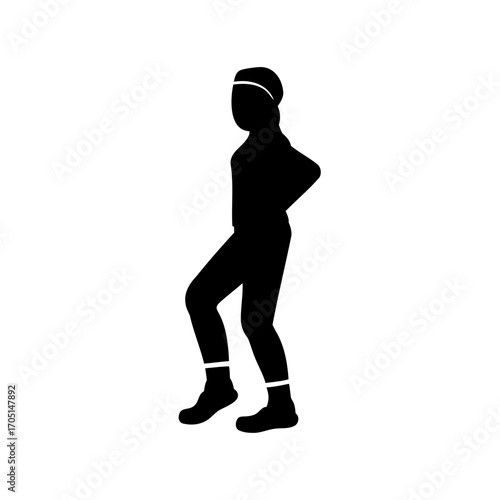 Silhouette of a woman in athletic wear strikes a dynamic pose with poise