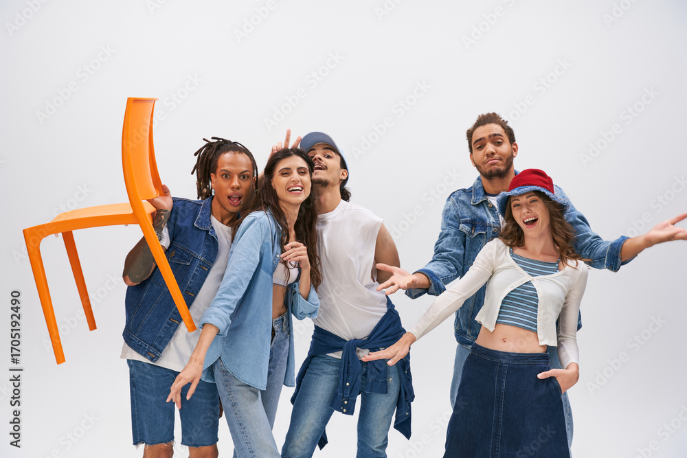 Fototapeta premium Young stylish friends celebrate friendship with fashion in a vibrant studio setting