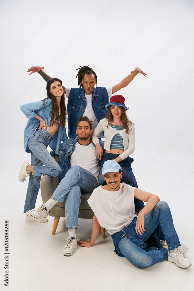 Fototapeta premium Young friends showcase trendy styles in a casual, lively indoor setting filled with joy