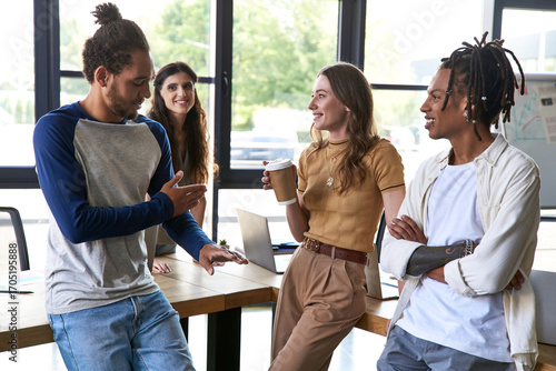 Fotografi Engaging discussions among young stylish coworkers in a modern office environmen