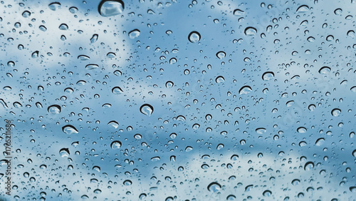 A closeup shot of the glass of a window covered by rain droplets for backgrounds and textures.