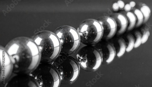 Reflective Chrome Spheres Chain on Dark Background