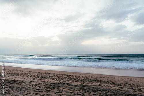 Ocean waves rolling onto sandy beach at Cabo da Roca, Portugal