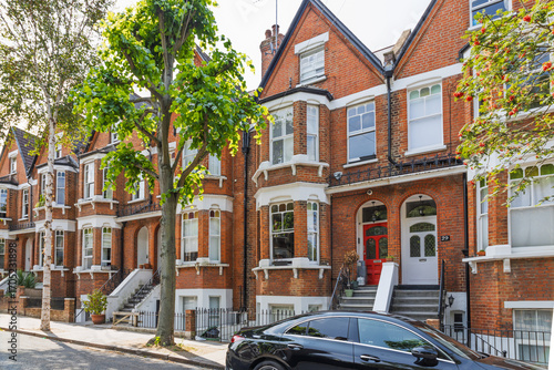 Classic Victorian Red Brick Terraced Houses on a Tree Lined London Residential Street