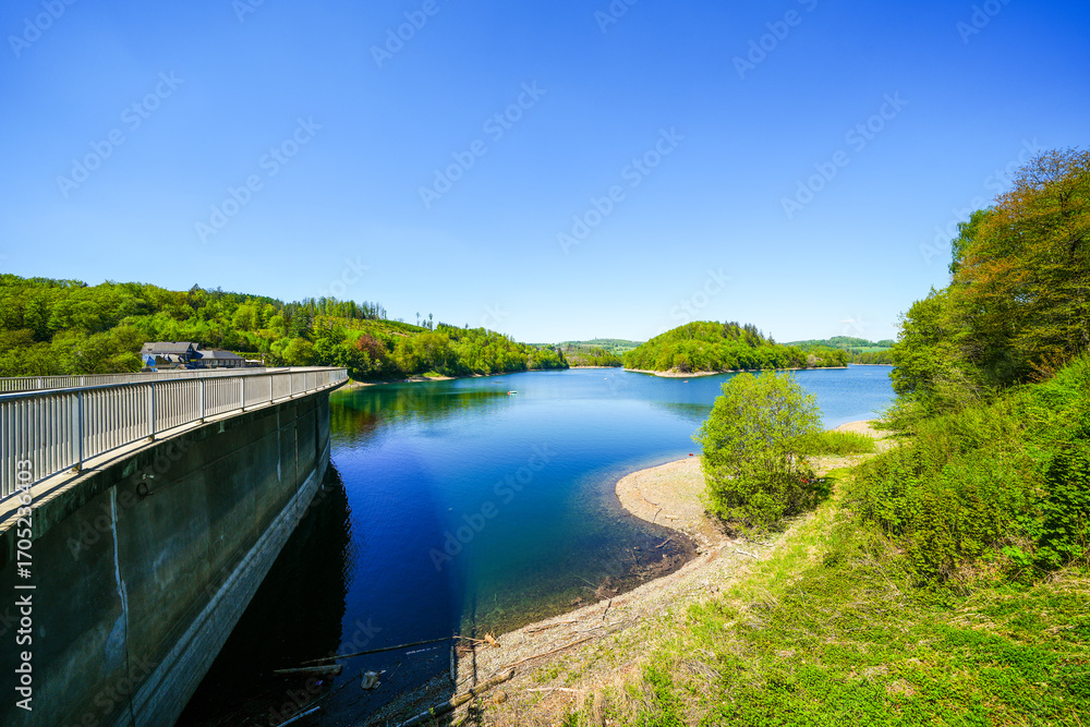 Fototapeta premium View of the Aggertalsperre Dam in the Oberbergisches Land region of North Rhine-Westphalia. A lakeside landscape with the surrounding nature.