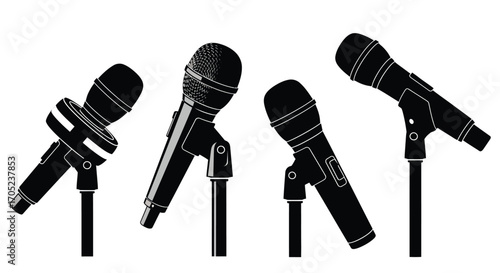 Four vintage microphones on stands silhouette