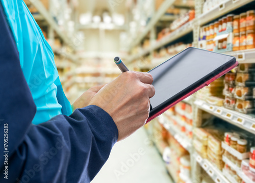 Logistic man and tablet in warehouse with scanner,stock and price for safety in supply chain or freight.Man industrial and quality control in manufacturing, shipping in trade for export at supermarket