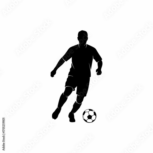 The silhouette of a soccer player dribbling the ball