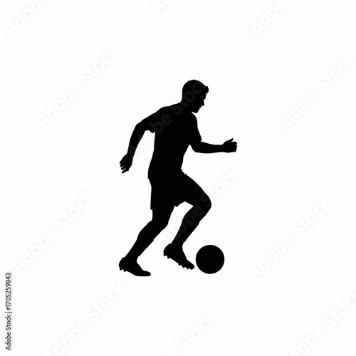 The silhouette of a soccer player dribbling the ball