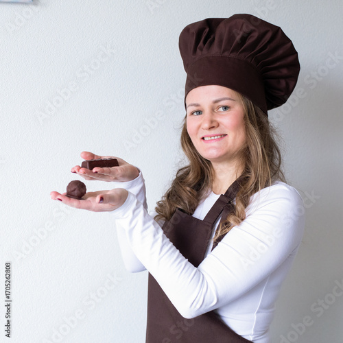 Chocolatier with handmade homemade chocolate balls in the hands