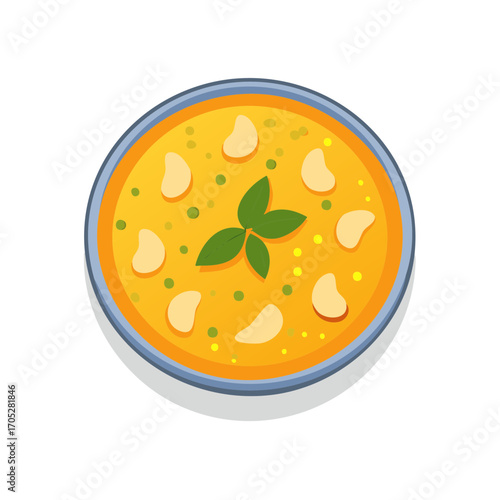 Overhead view of creamy soup with basil and dumpling-like pieces.