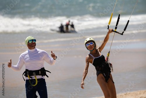Kitesurfing Training on the Beach with Instructor and Woman