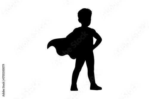 Silhouette of a young boy wearing a superhero cape and standing with hands on his hips heroically