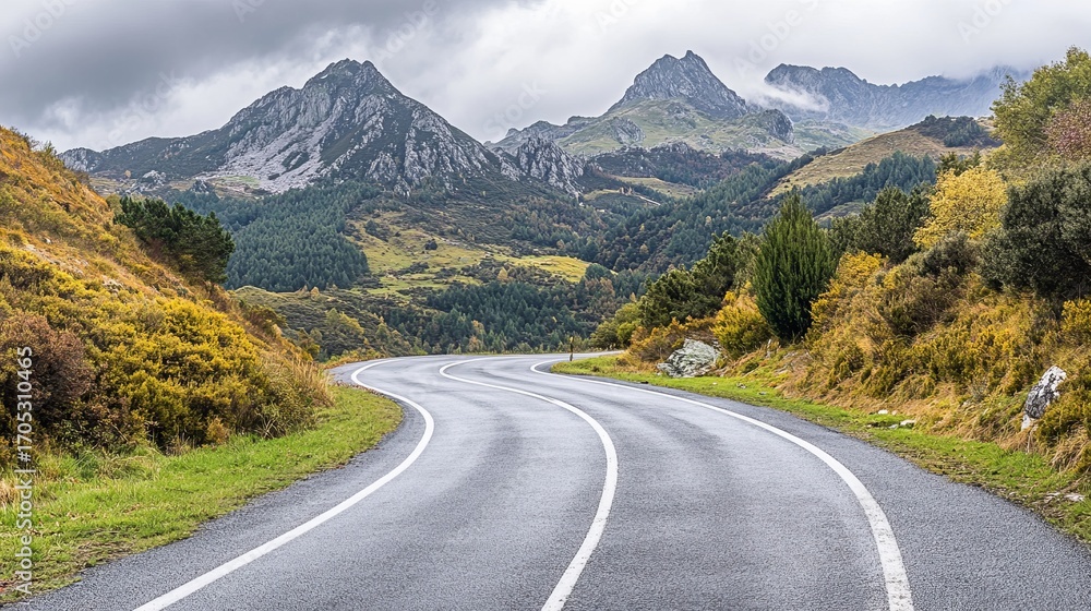Naklejka premium Winding road through autumnal mountains