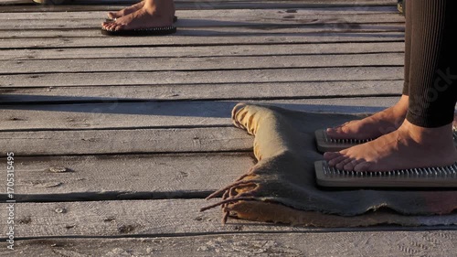 A close-up of a woman's bare feet on a Sadhu board. The image highlights a spiritual practice for self-discovery, mindfulness, and wellness.