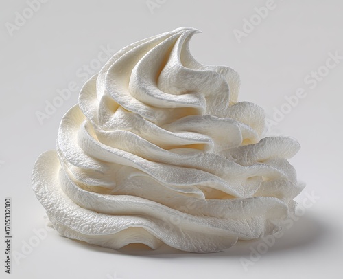 Whipped cream mound against a plain background