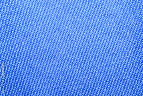 A detailed macro photograph capturing the fine, tight weave and uniform textured surface of a brightly colored textile, ideal for a simple and striking background.